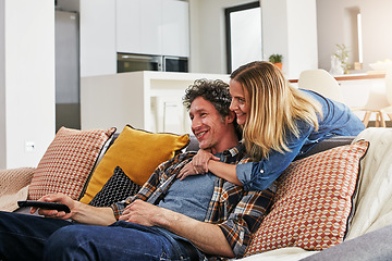 Image showing Happy couple, hug and watching tv in home for movie, film show and news broadcast in living room. Mature man, woman and smile on sofa for television series, video subscription and streaming platform