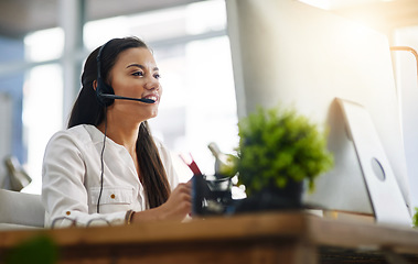 Image showing Communication, customer services or woman in call center consulting, speaking or talking at help desk. Virtual assistant, friendly or sales consultant in telemarketing or telecom company office