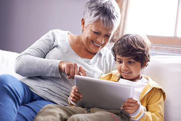 Image showing Tablet, grandmother and kid education app at home on living room sofa with happiness and bonding. Family, house couch and lounge with senior woman and child on technology watching a video with smile