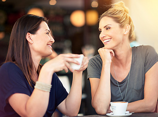 Image showing Conversation, cafe and female friends drinking coffee together while talking and bonding for gossip. Happy, smile and women speaking, laughing and enjoying a warm beverage at a restaurant in the city