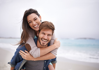Image showing Love, piggyback and portrait of couple at a beach, hug and laughing while bonding outdoors. Face, embrace and happy man with woman at ocean for travel, freedom or vacation, holiday or Florida trip