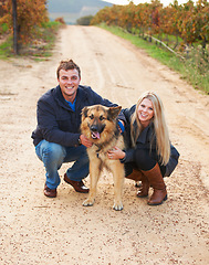 Image showing Portrait, nature and a couple walking their dog outdoor on a dirt road while bonding together for love. Happy, agriculture or sustainability with a man and woman taking their pet for a walk on a farm