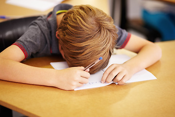 Image showing Sleeping, bored and notebook with boy in classroom for learning, education and knowledge. Stress, anxiety and tired with male student with notebook at school for exhausted, dreaming and frustrated