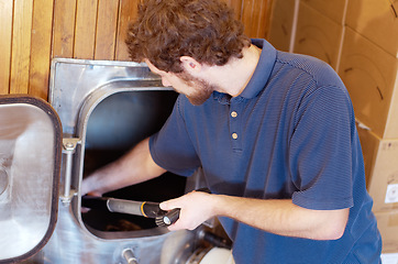 Image showing Man is working in brewery, beer manufacturing and productivity in distillery and alcohol industry. Industrial equipment, production of alcoholic drink and male worker brewing cider beverage