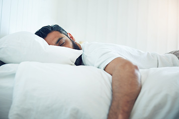 Image showing Tired, relax and a man on a bed for sleep, depression and fatigue at home. Rest, napping and a guy sleeping in the bedroom with insomnia, narcolepsy or depressed while lying looking exhausted