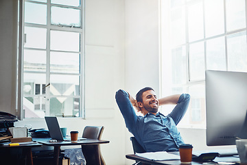 Image showing Relax, office and businessman with hands behind his head after project success or achievement. Rest, productivity and professional male employee with finish work sitting by his desk in the workplace.