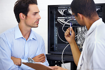 Image showing Server room, it support and cable with an engineer chatting to a business man about network management. Maintenance, database and clipboard with a technician chatting about information technology
