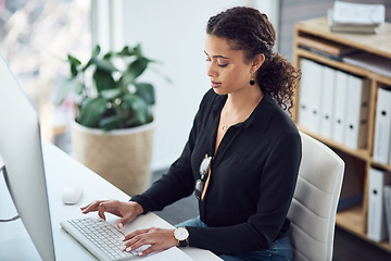 Image showing Professional, typing and a woman with an email on a computer, research or secretary work. Analytics, desk and a African female receptionist with a pc in an office for connectivity and working