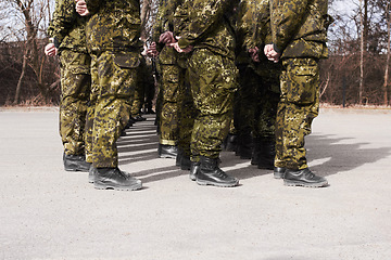 Image showing Army, military and group of soldiers training together outdoor for war, service or mission. Feet of men or team in formation for exercise, safety and security in camouflage uniform as defence