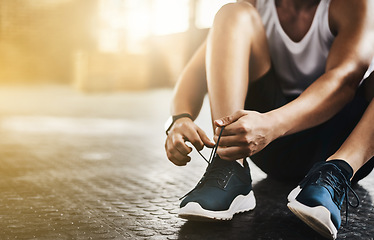 Image showing Fitness, gym and man tie shoes before a workout for health, wellness and endurance training. Sports, healthy and closeup of male athlete preparing while tying laces before a exercise in sport center.