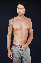 Image showing Model, man and muscle with tattoo on body in jeans for motivation with dark background. Male person, healthy and strong with sexy chest for training or shirtless after workout or exercise.