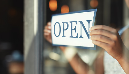 Image showing Open sign, restaurant window and hands of person, small business owner or manager with cafe door poster for welcome. Retail sales waitress, coffee shop barista and closeup board for store service