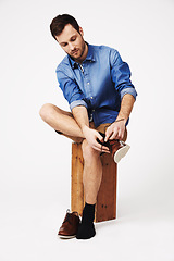 Image showing Fashion, shoes and man in studio against white background for getting ready or dressing. Socks, choice and casual male with outfit for style, decision and fashionable or trendy clothing aesthetic