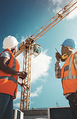 Image showing Construction, engineering and team with walkie talkie and crane for building project, teamwork or architecture. Black woman and man manager together for engineer planning or safety inspection outdoor