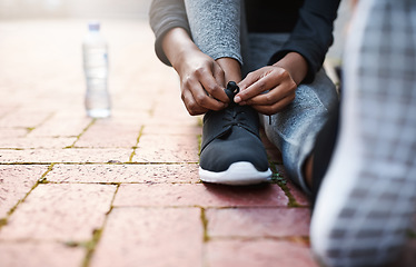 Image showing Running shoes, woman athlete and tie lace or start training or hands fitness and isolated on floor outdoors. Exercise, marathon and female runner outside or preparing for jog on mock up background