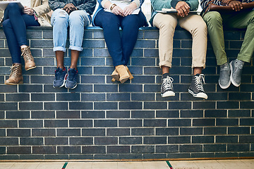 Image showing Closeup, legs and students with education, wall and knowledge on a break, relax and university. Zoom, group and young people with sneakers, shoes and campus with fashion, scholarship and opportunity