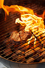 Image showing Barbecue, food and steak on a fire for dinner, eating meat and cookout on the grill. Protein, flame and food grilling for a bbq and preparing beef for supper for hunger or health outdoors at home