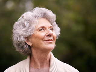 Image showing Happy senior woman, smile and thinking in nature for hope, joy or retirement in the outdoors. Face of thoughtful elderly female smiling in happiness, future or reflection for natural life or vitality