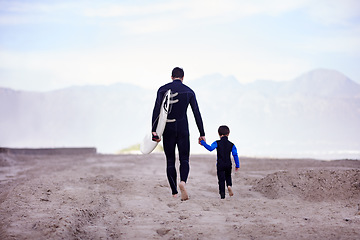 Image showing Beach, father and son with surfing lesson, walking and bonding on summer vacation, loving and quality time. Family, parent and dad with boy, male child and kid with surfboard and seaside holiday