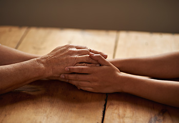 Image showing Support, unity and closeup of people holding hands for grief, hope and sympathy after loss. Gratitude, empathy and friends in an intimate moment with affection for love, trust and solidarity on table