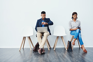 Image showing Phone, laptop and people in waiting room for an internship search the internet, web or website sitting on chairs. Interview, work and young employees texting and typing online ready for a new job