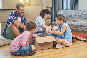 Image showing Family, kids and moving with boxes for apartment as an investment for lifestyle together in a house. Children, box and parents in living room of a new home are packing for the mortgage for saving.