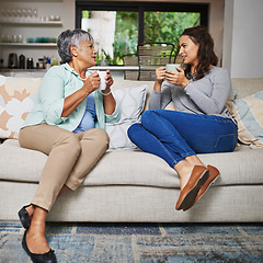 Image showing Relax, coffee and mother with daughter on sofa in living room for bonding, conversation and happiness. Smile, chat and discussion with women talking in family home for generations, reunion and break