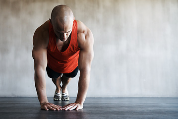 Image showing Workout, gym and man in floor push up for exercise, health commitment or training for muscle growth. Fitness club mockup, healthy and body of strong person focus in athlete health challenge or pushup