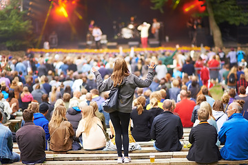 Image showing Back, woman and group at a music festival, cheering and happiness on a weekend break. Female person, people and happy crowd at a party, dancing and joy with fun, excited and celebration for concert