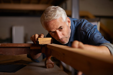 Image showing Senior carpenter, wood sanding and man with precision on building construction and architecture project. Home improvement, handyman and work of a mature male employee with carpentry tool for woodwork