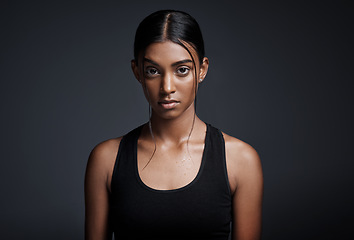 Image showing Portrait, serious and Indian woman with fitness, exercise and confident girl against a dark studio background. Face, female person and athlete with determination, endurance and workout for wellness