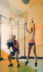 Image showing Fitness people, jump and medicine ball at gym for exercise, workout and training goals. Athlete man and woman team together for power challenge, energy or strong muscle at wellness club with overlay