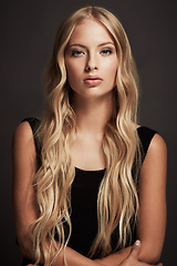 Image showing Sexy, portrait and woman with beauty, confident and glamour against a dark studio background. Face, female person and model with wellness, black dress and elegant outfit with fashion and luxury