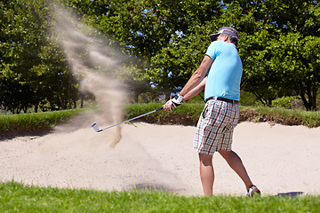 Image showing Golf, sport and a man on course for training, professional game or a hobby in retirement. Sand, summer and an elderly player hitting a ball with a club for sports, golfing and recreation as a senior