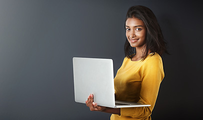 Image showing Laptop, portrait and woman blogging or working online, internet or web isolated on a gray studio background. Mockup, social media and happy female person or student writing and using technology