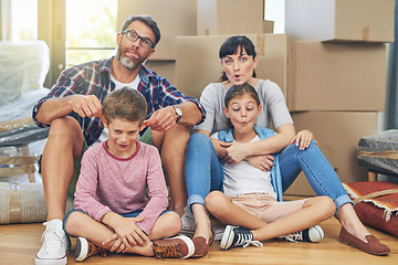 Image showing Family, portrait and funny face in apartment with boxes as an investment for mortgage in real estate. Kids, parents and box with comic mood in new house with happiness are silly on the floor.