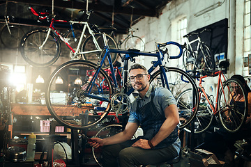 Image showing Portrait, wrench and mechanic man in bicycle shop, store or cycling repair workshop. Face, bike technician and male person, serious business owner or mature professional with glasses and confidence.