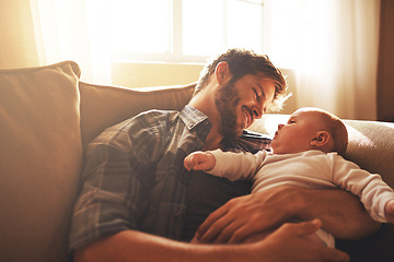 Image showing Father, baby and love on a family home sofa with love, care and support for a child. Happy man or dad with a smile and kid for bonding, development and growth or happiness in relationship with parent