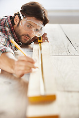 Image showing Wood, carpenter man building project and measurement with tape at construction site. Home renovation or furniture design, handyman working on maintenance at workshop and woodwork or handcraft