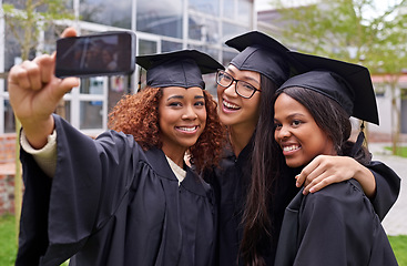 Image showing Education, women celebrating graduation with selfie and group at the ceremony outside on campus. University or college academic achievement, female students take photo and people dressed in cloaks