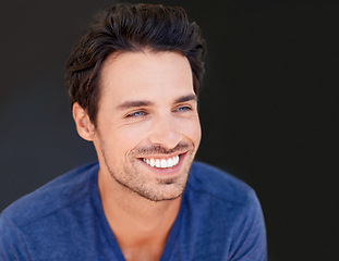 Image showing Face, smile and handsome man or happy male with white teeth or oral hygiene and isolated on a dark, black background. Motivated, cheerful and attractive guy or dental health or beauty in studio