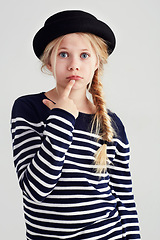 Image showing Serious, confused and portrait of a girl with fashion isolated on a white background in studio. Doubt, confusion and a young child looking puzzled in fashionable, stylish and trendy clothes for youth