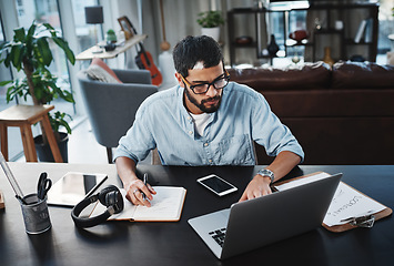 Image showing Laptop, remote work and man with a notebook for planning a creative freelance project at his home. Technology, reading and male freelancer doing research on computer while working in his living room.