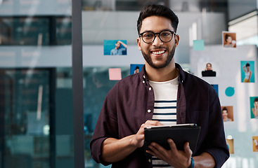 Image showing Technology, portrait of happy businessman with tablet and standing in office at work. Social media or networking, Corporate and creative young man with mobile device checking emails at workplace