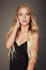 Image showing Beauty, portrait of young woman and in studio backdrop. Person marketing or advertising self care and elegant or serious female model promote skincare or cosmetic posing in isolated background