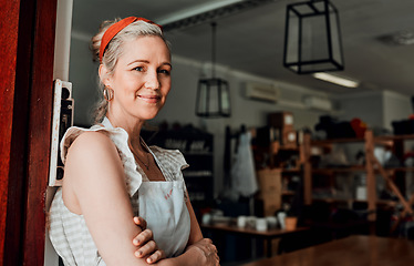 Image showing Happy woman, portrait and arms crossed by entrance in small business confidence for workshop in retail store. Confident female person, ceramic designer or owner smiling for craft or creative startup