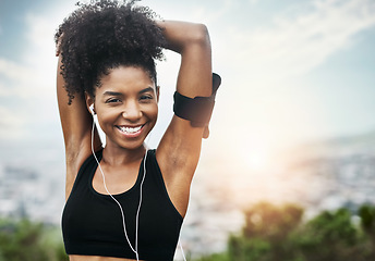Image showing Fitness, portrait and happy woman stretching outdoors with music for running, workout or cardio. Face, smile and African female runner in nature with podcast for training, motivation or sport routine
