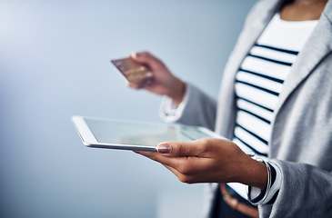 Image showing Woman, tablet in hands with credit card and online shopping, ecommerce and fintech on studio background. Digital payment, finance and professional female person with internet banking and connectivity