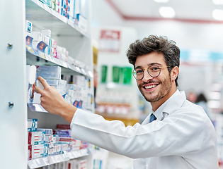 Image showing Pharmacist, medicine and portrait of a man working in a pharmacy store for retail career with a smile. Male person in pharmaceutical or medical industry for service, healthcare and inventory on shelf