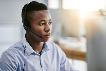 Image showing Virtual assistant, consultant or black man in call center consulting online at customer services help desk. Contact us, email or serious African agent in telemarketing, CRM or telecom company office